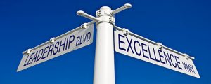 street post with leadership blvd and excellence way signs